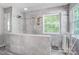 Updated bathroom featuring a glass-enclosed shower with neutral-toned tile and a window at 62 Pond View Ln, Fort Mill, SC 29715
