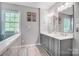 Modern bathroom showcasing double sinks with gray cabinets and decorative artwork above at 62 Pond View Ln, Fort Mill, SC 29715