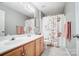 Bathroom with light wood cabinets, a floral shower curtain, and neutral wall paint at 62 Pond View Ln, Fort Mill, SC 29715