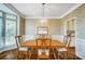 Charming dining room with a wooden table, six chairs, and decorative wallpaper at 62 Pond View Ln, Fort Mill, SC 29715