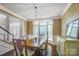 Elegant dining room with a chandelier, large windows, and classic wallpaper at 62 Pond View Ln, Fort Mill, SC 29715