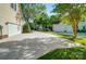 Long concrete driveway leading to attached garages, surrounded by mature trees and lush landscaping at 62 Pond View Ln, Fort Mill, SC 29715