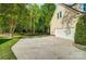 Long driveway leading up to the exterior of a home with a 2-car garage and well-kept lawn at 62 Pond View Ln, Fort Mill, SC 29715