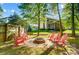 Outdoor firepit area with surrounding chairs and a view of the backyard and surrounding neighborhood at 62 Pond View Ln, Fort Mill, SC 29715