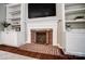 Close up of fireplace with brick interior and white built-in shelves at 62 Pond View Ln, Fort Mill, SC 29715