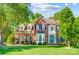 Beautiful two-story brick home with a well-manicured lawn and lush landscaping at 62 Pond View Ln, Fort Mill, SC 29715