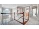Upstairs hallway featuring carpet flooring, wood railing, and access to various rooms at 62 Pond View Ln, Fort Mill, SC 29715