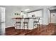 Stylish kitchen bar area with granite countertops, seating for three, and modern fixtures at 62 Pond View Ln, Fort Mill, SC 29715