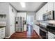 Bright kitchen featuring stainless steel refrigerator, white cabinets, and hardwood floors at 62 Pond View Ln, Fort Mill, SC 29715
