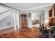 Spacious living room with beautiful hardwood floors, a staircase, and an antique china cabinet at 62 Pond View Ln, Fort Mill, SC 29715