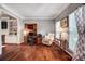 Inviting living room with dark wood floors, built-in shelving, a cozy chair, and a desk space at 62 Pond View Ln, Fort Mill, SC 29715