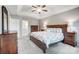 Bright main bedroom featuring a tray ceiling, floral bedding, and dark wood furniture at 62 Pond View Ln, Fort Mill, SC 29715