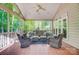 Inviting screened porch with comfortable seating and a peaceful view of the wooded backyard at 62 Pond View Ln, Fort Mill, SC 29715