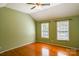 Spacious bedroom featuring vaulted ceilings, wood floors, and natural light from two windows at 6779 Highway 557 Hwy, Clover, SC 29710