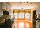 Open concept dining room featuring hardwood floors, bay windows and stone accent walls at 6779 Highway 557 Hwy, Clover, SC 29710