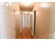 Hallway with hardwood floors, connecting various rooms and creating a seamless flow throughout the home at 6779 Highway 557 Hwy, Clover, SC 29710