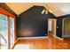 Living room featuring hardwood floors, dark colored walls, and glass patio doors at 6779 Highway 557 Hwy, Clover, SC 29710