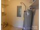 Utility room with hot water heater, electrical box, and overhead shelving at 6779 Highway 557 Hwy, Clover, SC 29710