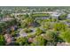 Expansive aerial view of property highlighting lush green landscaping and nearby commercial district at 6809 Copernicus Cir, Charlotte, NC 28226