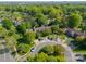 Aerial view of community featuring lush trees, green space, and multiple townhomes at 6809 Copernicus Cir, Charlotte, NC 28226