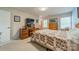Bright bedroom featuring a wooden desk, a quilt-covered bed and light colored walls at 6809 Copernicus Cir, Charlotte, NC 28226