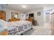 Bright bedroom featuring a wooden dresser, a quilt-covered bed and light colored walls at 6809 Copernicus Cir, Charlotte, NC 28226