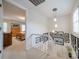 Hallway with bedroom access, showcasing pendant lighting and framed artwork along the staircase wall at 6809 Copernicus Cir, Charlotte, NC 28226