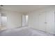 Bright bedroom featuring neutral carpet, a double door closet, and access to an ensuite bathroom with tub at 6815 Old Post Rd, Charlotte, NC 28212