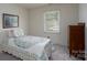 Cozy bedroom featuring a comfortable bed, classic dresser, and a sunlit window at 6815 Old Post Rd, Charlotte, NC 28212