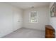 Bright bedroom with carpeted floor, closet, and a window providing natural light at 6815 Old Post Rd, Charlotte, NC 28212