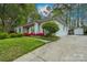 A bright white brick home featuring an ADT security sign and flowering azaleas lining the front of the house at 6815 Old Post Rd, Charlotte, NC 28212