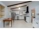 Open kitchen featuring stainless steel appliances, white cabinets and wood beam accents at 6815 Old Post Rd, Charlotte, NC 28212