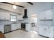 Updated kitchen with white cabinetry, stainless steel appliances, and view to dining room at 6815 Old Post Rd, Charlotte, NC 28212