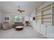Comfortable living room with built-in shelving, ceiling fan, and lots of natural light at 6815 Old Post Rd, Charlotte, NC 28212