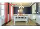 This dining room has navy walls, white trim, modern chandelier, and a neutral rug at 7023 Butternut Oak Ter, Huntersville, NC 28078