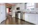Well-equipped kitchen with stainless steel appliances, white cabinets, granite countertops, and dark hardwood flooring at 7023 Butternut Oak Ter, Huntersville, NC 28078