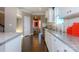 Stylish kitchen featuring granite countertops, white cabinets, stainless appliances, and dark hardwood floors at 7023 Butternut Oak Ter, Huntersville, NC 28078
