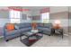 Cozy living room with an L shape couch that allows natural light to brighten the room at 7023 Butternut Oak Ter, Huntersville, NC 28078