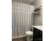 Charming bathroom with a decorative shower curtain and open shelving for storage at 715 Cody Ct, Fort Mill, SC 29715