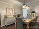 Elegant dining room featuring a modern light fixture, dining table set for four, and decorative accents at 715 Cody Ct, Fort Mill, SC 29715
