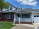 Charming home featuring a blend of brick and siding, complemented by a cozy front porch and well-manicured lawn at 715 Cody Ct, Fort Mill, SC 29715