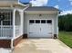 This garage has a white door with decorative hardware, exterior lighting, and a well-maintained driveway at 715 Cody Ct, Fort Mill, SC 29715