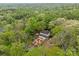 Aerial view of a home showcasing lush surrounding landscape and an attractive brick-walled garden at 740 Woodlawn Ave, Mount Holly, NC 28120