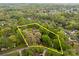 Aerial view of the property showcasing extensive tree coverage and surrounding neighborhood at 740 Woodlawn Ave, Mount Holly, NC 28120