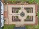 Overhead view of a brick-walled garden with gravel paths and a central water feature at 740 Woodlawn Ave, Mount Holly, NC 28120