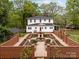 Rear exterior of home featuring an elaborate garden and lush landscaping to create a backyard oasis at 740 Woodlawn Ave, Mount Holly, NC 28120