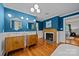 Stylish bathroom featuring dual vanity sinks, hardwood floors, and a decorative fireplace at 740 Woodlawn Ave, Mount Holly, NC 28120