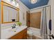 A bathroom with an enclosed shower-tub combination and a modern sink basin and fixtures at 740 Woodlawn Ave, Mount Holly, NC 28120