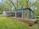 Exterior view of a detached garage featuring a modern design and spacious deck at 740 Woodlawn Ave, Mount Holly, NC 28120
