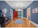 Bright foyer with a colorful front door, hardwood floors, modern lighting, and a stylish console table at 740 Woodlawn Ave, Mount Holly, NC 28120